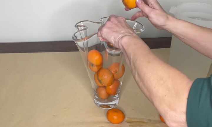 3 easy citrus dcor ideas to upgrade your home for the holidays, Adding oranges to a clear glass vase