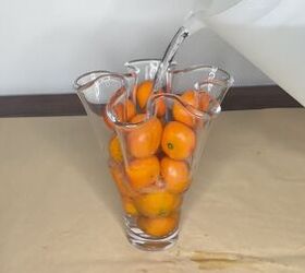 3 easy citrus dcor ideas to upgrade your home for the holidays, Adding water to a vase filled with oranges