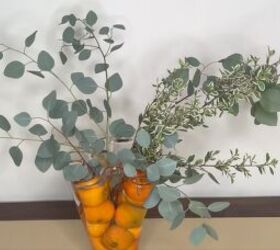 3 easy citrus dcor ideas to upgrade your home for the holidays, Greenery added to a vase filled with oranges