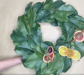 3 easy citrus dcor ideas to upgrade your home for the holidays, Attaching dried citrus slices to artificial magnolia wreath