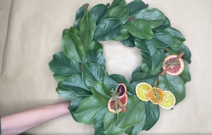 3 easy citrus dcor ideas to upgrade your home for the holidays, Attaching dried citrus slices to artificial magnolia wreath