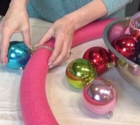 a breathtaking jumbo christmas ball wreath in 3 easy steps, Gluing Christmas balls to the wreath form