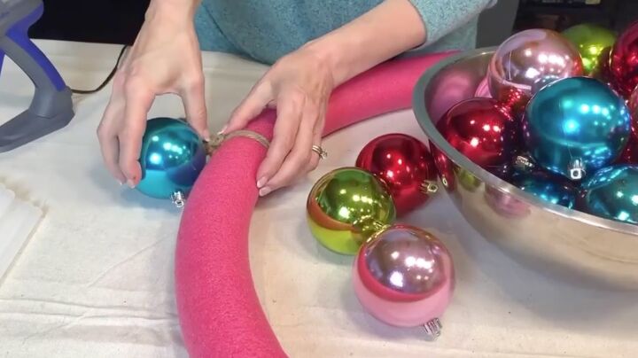 a breathtaking jumbo christmas ball wreath in 3 easy steps, Gluing Christmas balls to the wreath form