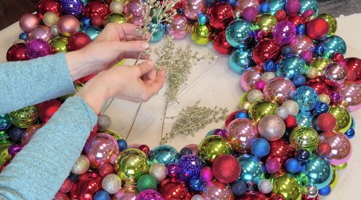 a breathtaking jumbo christmas ball wreath in 3 easy steps, Adding Christmas picks to the Christmas ball wreath