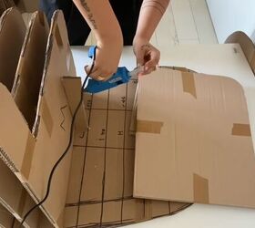 how to make a diy cardboard couch in a chic round style, Hot gluing the connection pieces to the base