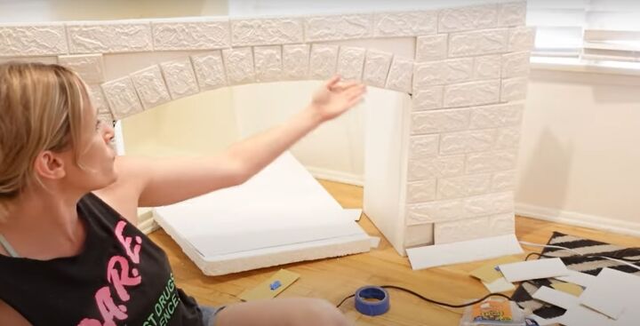 how to make an easy diy foam fireplace without using power tools, Placing the brick tiles on the facade