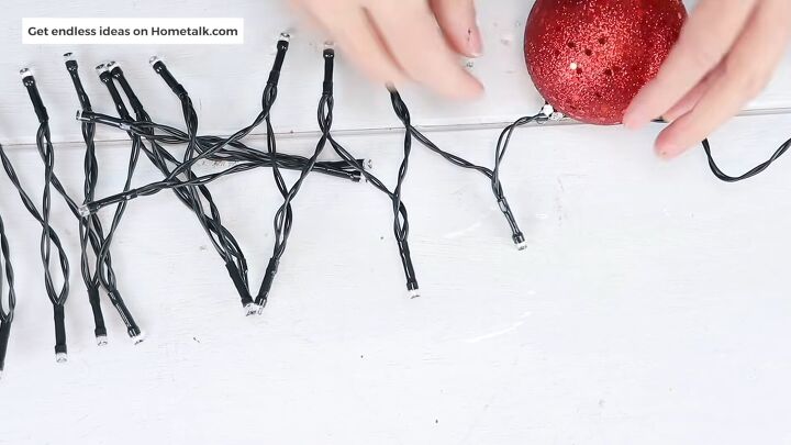 christmas decor how to make a beautiful diy ornament garland, The first ornament attached to the string lights