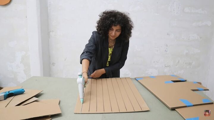 how to make a cardboard chair that holds weight looks chic, Applying hot glue to the base