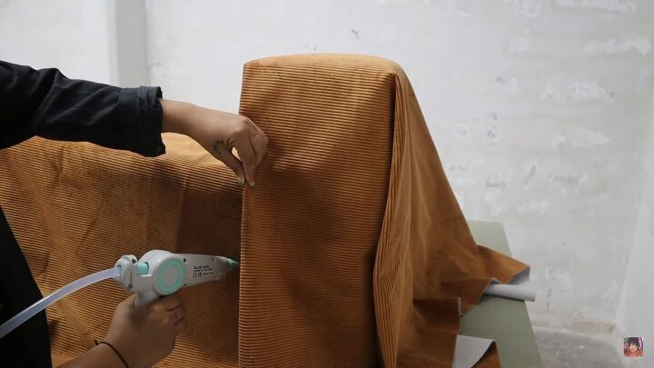 how to make a cardboard chair that holds weight looks chic, Sticking the folded edges in place with hot glue