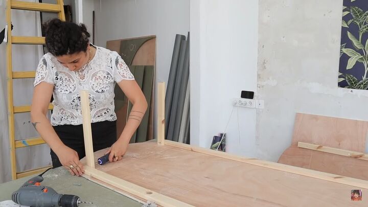 how to make a funky diy couch out of pool noodles, Drilling the beams in place