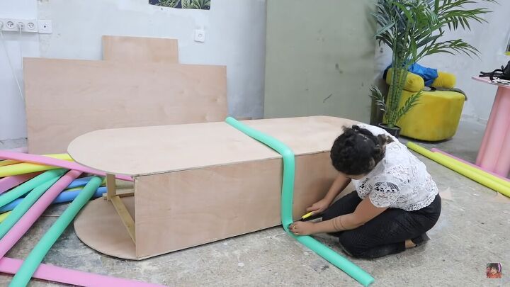 how to make a funky diy couch out of pool noodles, Placing the pool noodles on the couch