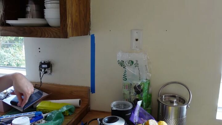 how to do a 70s old kitchen cabinets makeover on a budget, Applying painter s tape to the walls