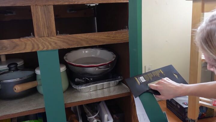 how to do a 70s old kitchen cabinets makeover on a budget, Applying contact paper on cabinets