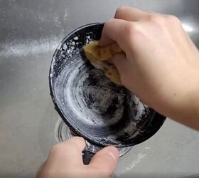 7 money saving cornstarch cleaning hacks for a spotless home, Scrubbing a greasy pan with cornstarch and a sponge