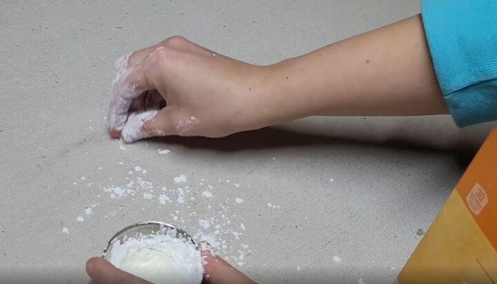7 money saving cornstarch cleaning hacks for a spotless home, Rubbing a cornstarch paste onto an oily stain on fabric