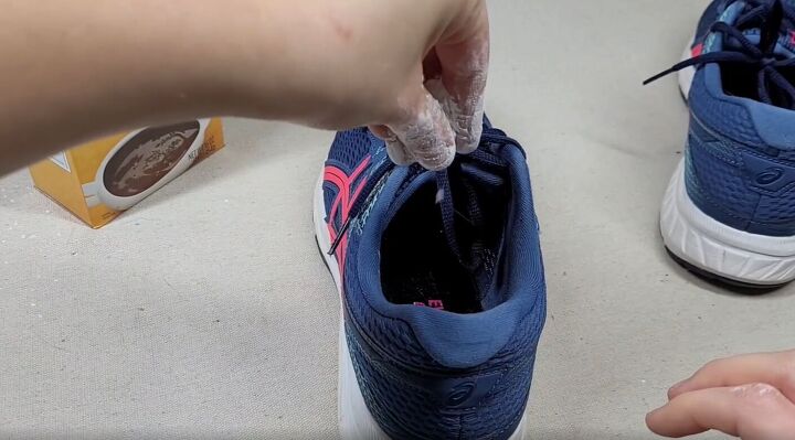 7 money saving cornstarch cleaning hacks for a spotless home, Sprinkling cornstarch into a sneaker