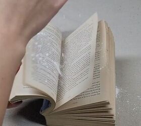 7 money saving cornstarch cleaning hacks for a spotless home, Sprinkling cornstarch into the pages of a musty book