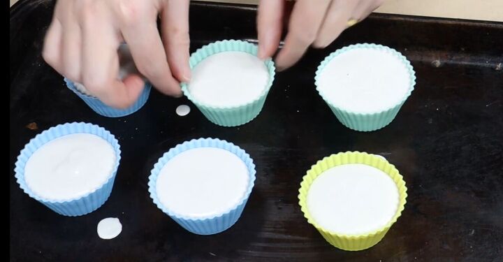how to create stunning cupcake candle holders with plaster of paris, Gently tapping a silicone mold against the tray to remove air bubbles