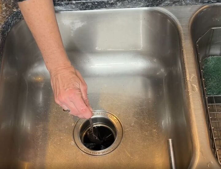 7 astonishing coffee grounds hacks to save you time and money, Coffee grounds being placed in a garbage disposal