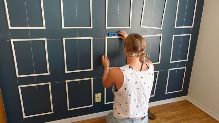 how to create an impressive dining room accent wall for only 70, Using command strips to attach the frames