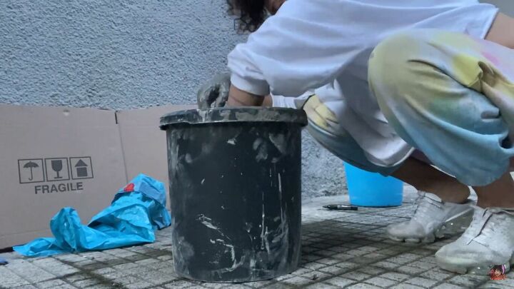 how to make a concrete side table with a cool optical illusion, Dipping the towel in concrete