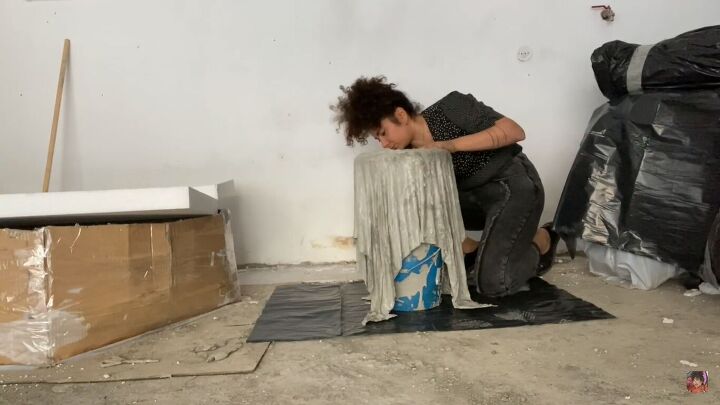 how to make a concrete side table with a cool optical illusion, Removing the buckets