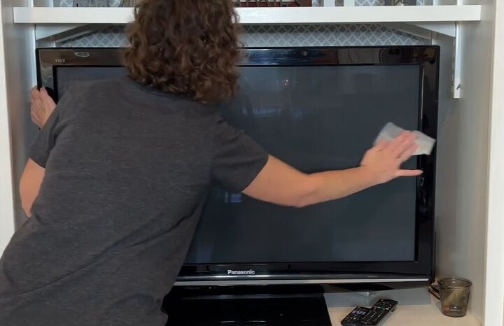 6 dryer sheet hacks the secret to effortless cleaning, Dusting a TV with a dryer sheet