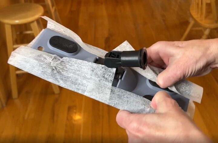 6 dryer sheet hacks the secret to effortless cleaning, Tucking dryer sheets into a Swiffer mop head