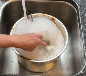 6 dryer sheet hacks the secret to effortless cleaning, Soaking a dryer sheet inside a dirty pot with soapy water