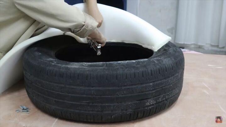 diy boa pouf dupe how to make a cute donut chair, Stapling foam to the tire