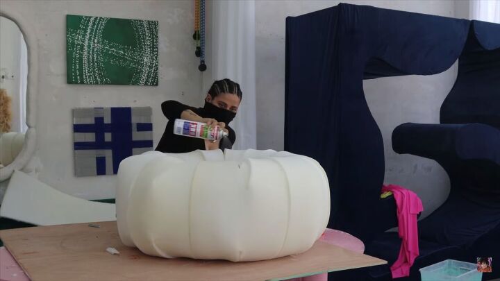 diy boa pouf dupe how to make a cute donut chair, Spraying the DIY boa pouf with glue