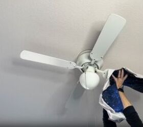 diy dust removal guide how to effortlessly banish dust, Cleaning the dust off a ceiling fan blade with an old pillowcase
