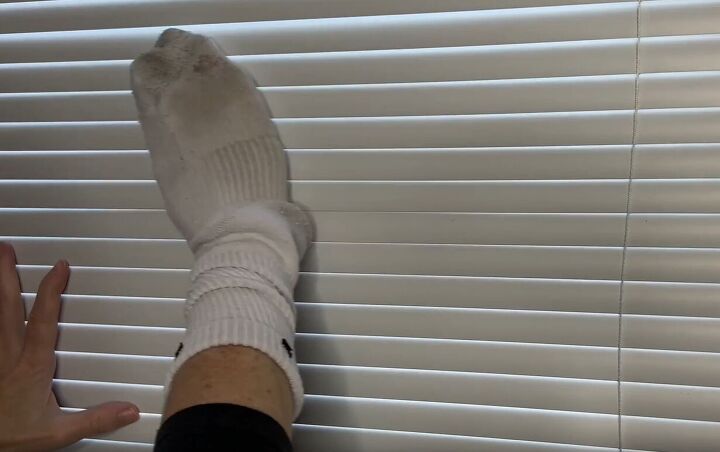 diy dust removal guide how to effortlessly banish dust, Using an old sock to clean the dust off of blinds