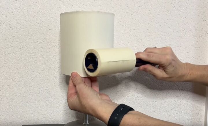 diy dust removal guide how to effortlessly banish dust, Rolling a lint roller on a lamp shade