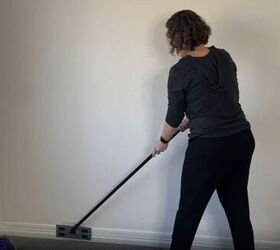 diy dust removal guide how to effortlessly banish dust, Cleaning baseboards with a dryer sheet on a dollar store sweeper