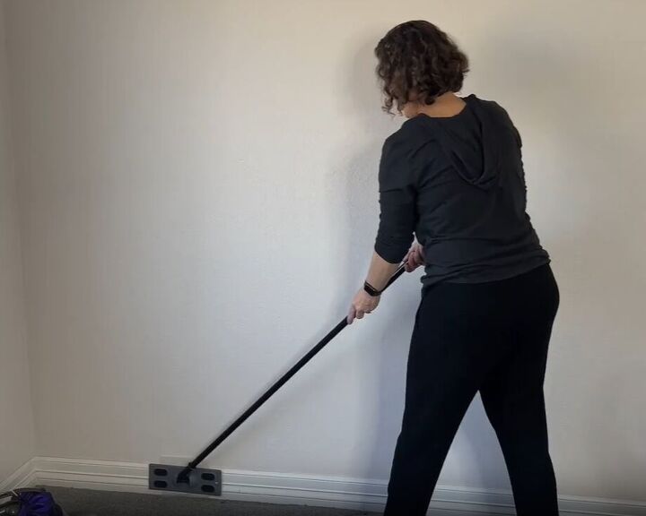diy dust removal guide how to effortlessly banish dust, Cleaning baseboards with a dryer sheet on a dollar store sweeper