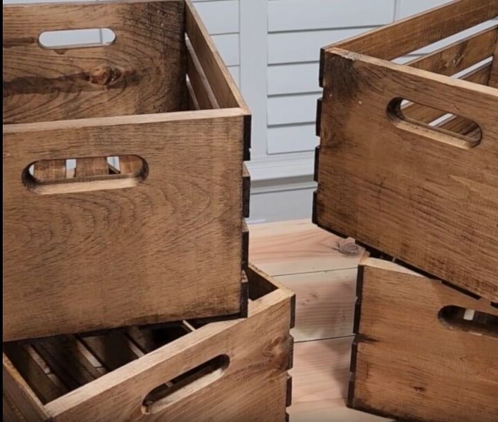 how to make an impressive rustic diy wood crate coffee table, Stained wooden crates stacked in pairs