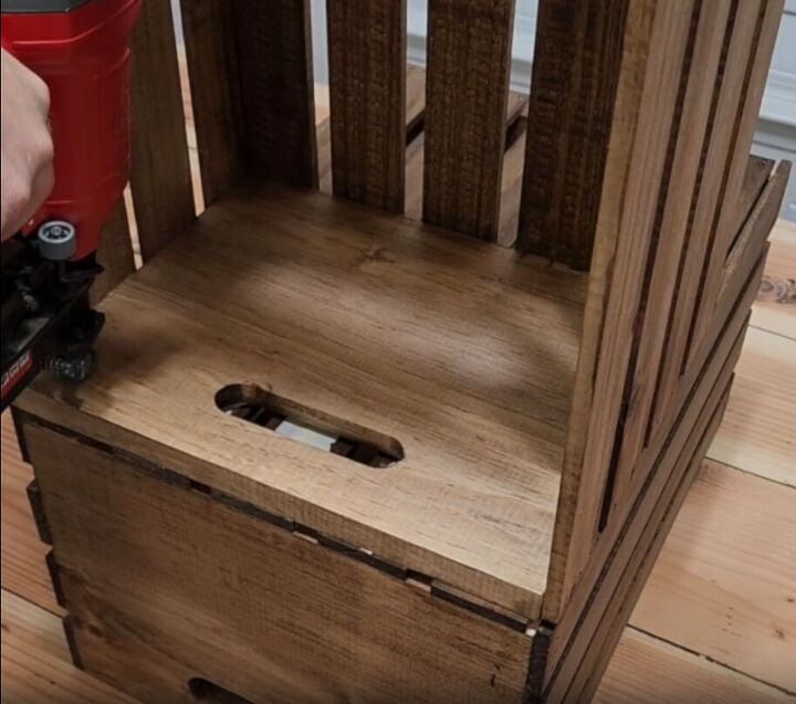 how to make an impressive rustic diy wood crate coffee table, Attaching two wooden crates together with brad nails