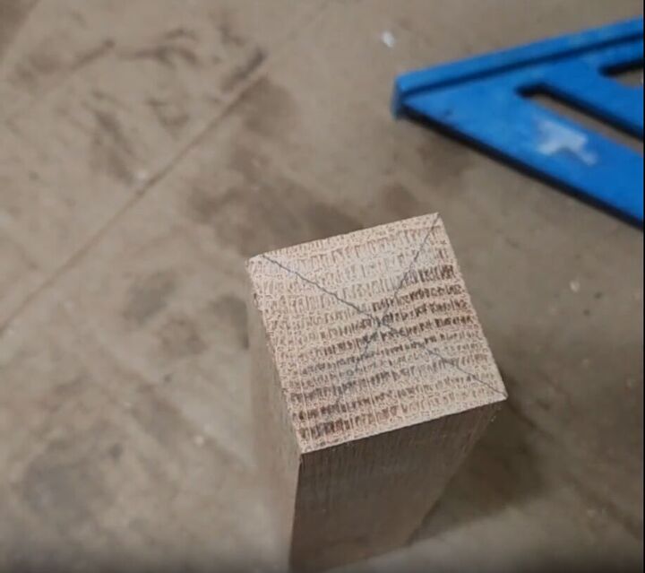 how to make an impressive rustic diy wood crate coffee table, An X marked on the top of a 2 x 2 wood piece marking the center point