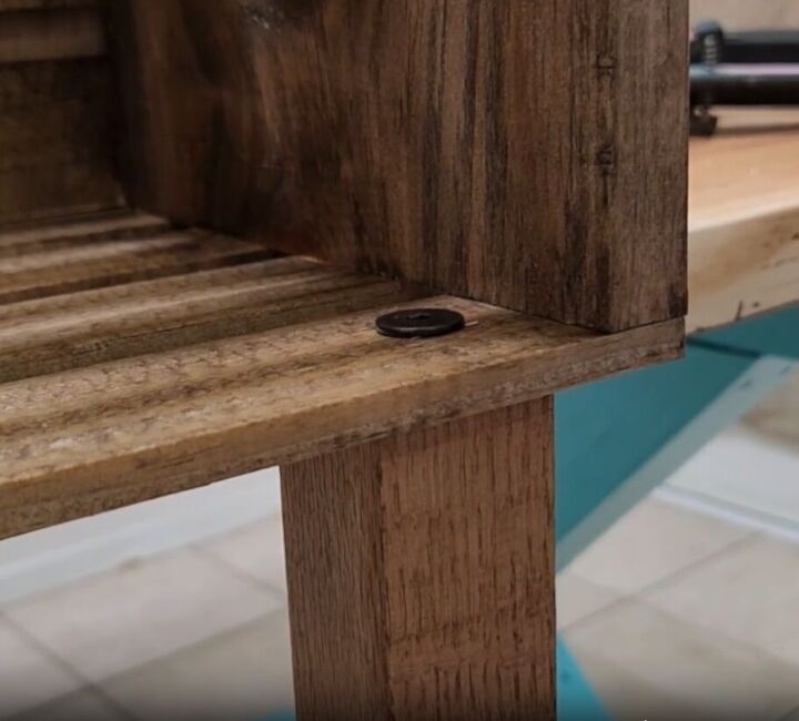 how to make an impressive rustic diy wood crate coffee table, A leg attached to the DIY crate table