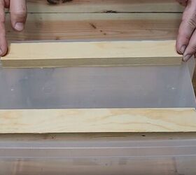 3 easy steps to a stylish diy plastic storage bin makeover, Gluing wooden strips to the bottom of a plastic container