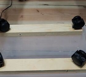 3 easy steps to a stylish diy plastic storage bin makeover, Four caster wheels attached to wood planks screwed into the bottom of a plastic storage container
