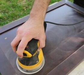 how to totally transform your bathroom in just one weekend, Sanding the cabinet doors with an electric sander