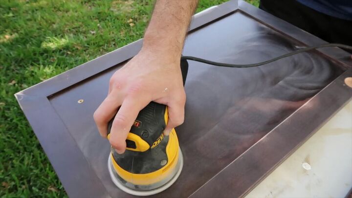 how to totally transform your bathroom in just one weekend, Sanding the cabinet doors with an electric sander