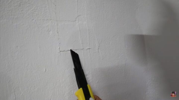 how to create an industrial exposed concrete accent wall for free, Cutting a square in the paint with a precision knife