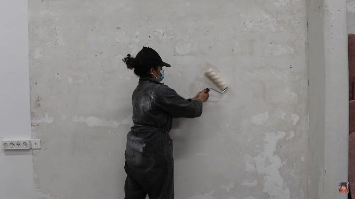 how to create an industrial exposed concrete accent wall for free, Applying paint sealer over the concrete wall