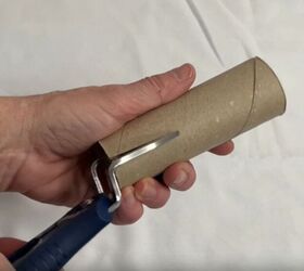 She slides a cut paper towel tube onto a plastic hanger for this 5-minute hack