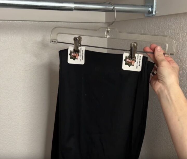 12 amazing hanger hacks to keep your home organized, Preventing creases in pants with business cards