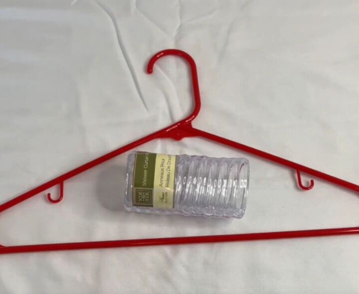 12 amazing hanger hacks to keep your home organized, Red plastic hanger and a package of shower curtain rings