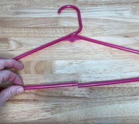 12 amazing hanger hacks to keep your home organized, A plastic hanger with a cut in the bottom center